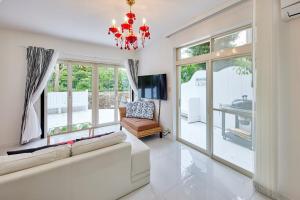 a living room with a couch and a chandelier at Sea Shell Kawazu House in Kawazu