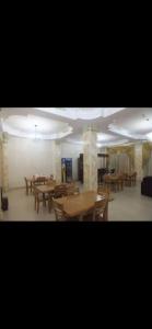 a dining room with wooden tables and chairs at DAVID Hotel in Yerevan
