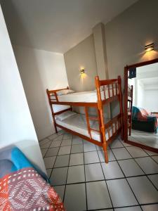 a small room with a bunk bed and a mirror at KITNETS Kretzer Hinckel 2 - CENTRO in Alfredo Wagner