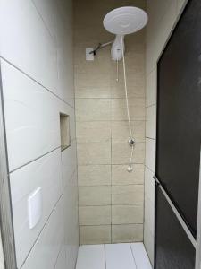 a bathroom with a shower with a shower head at KITNETS Kretzer Hinckel 2 - CENTRO in Alfredo Wagner