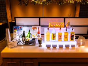 a counter with a bunch of bottles of alcohol on it at Super Hotel Hida Takayama in Takayama