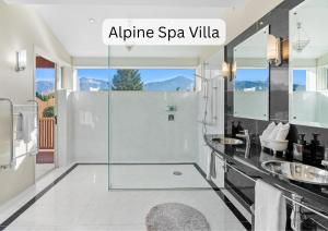 a bathroom with a shower with a glass door at Vibrant Living Retreat in Hanmer Springs +42 photos