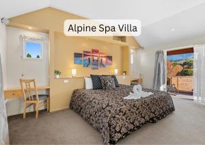 a bedroom with a bed and a desk in a room at Vibrant Living Retreat in Hanmer Springs