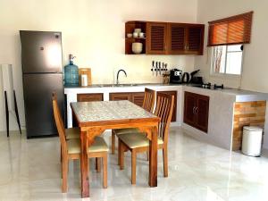 a kitchen with a table and chairs and a refrigerator at Duplex Villa 1 in Trat +8 photos