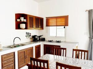 a kitchen with a sink and a table with chairs at Duplex Villa 1 in Trat