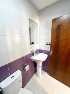 a bathroom with a toilet and a sink at Visit Chamal - Palmera 4 in Oued Laou