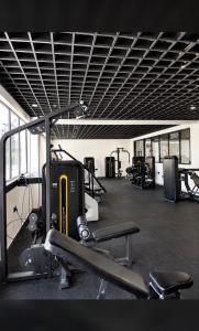 a gym with treadmills and machines in a room at Collins unique apartments in Ruaka +2 photos