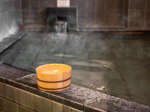 a candle sitting on top of a bath tub at Super Hotel Morioka in Morioka