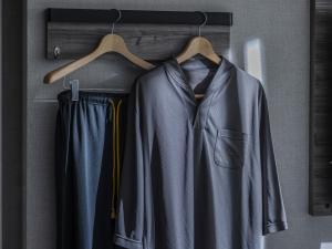 a coat and trousers hanging on a rack at Super Hotel Morioka in Morioka +25 photos