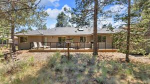 a house with a large porch in the woods at Mt. St. Helens - Unit 9 in Sunriver