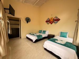 a room with two beds and a tv on the wall at Villa Cristina San Javier in La Mesa +52 photos