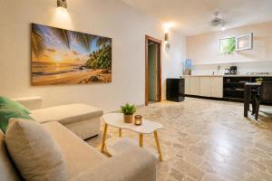 a living room with a couch and a table at Casa roof in Las Terrenas