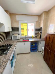 a kitchen with a sink and a counter top at Visit Chamal - Palmera 4 in Oued Laou +7 photos