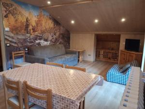 a living room with a table and a couch at Chalet Bianco in Valdidentro