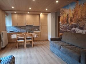 a living room with a couch and a table at Chalet Bianco in Valdidentro