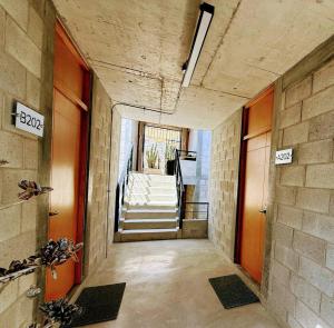a hallway of a building with stairs and a stairway at Santas y Santos in Todos Santos +14 photos