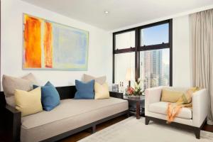 a living room with a couch and two chairs at Shama Central in Hong Kong