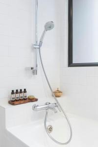 a shower in a bathroom with a sink at Shama Central in Hong Kong +34 photos