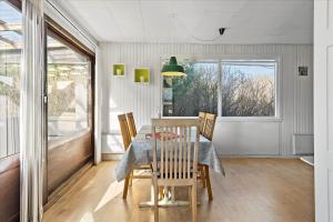 a dining room with a table and chairs and a window at 828-Thisted-Orredvej-13 in Thisted