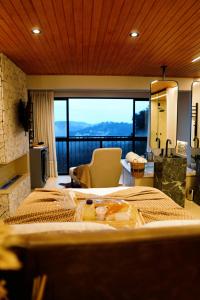 a bedroom with two beds and a large window at Moldavite Bungalow in Treze Tílias