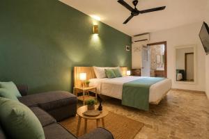 a bedroom with a bed and a living room with a couch at Casa roof in Las Terrenas
