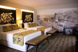 two beds in a hotel room with a painting on the wall at Casa del Alma Hotel Boutique & Spa in San Cristóbal de Las Casas +82 photos