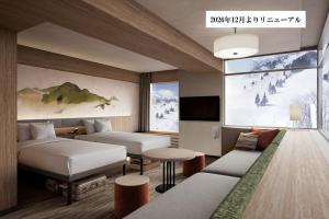 a hotel room with two beds and a tv at Naeba Prince Hotel in Yuzawa
