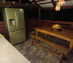 a kitchen with a table and a refrigerator at A-típico in Santa Marta