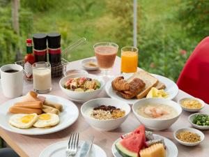 a table with plates of breakfast food on it at ibis Bangkok IMPACT in Nonthaburi
