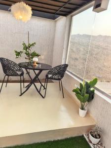 a patio with a table and chairs on a balcony at سكوْن in Al Baha +20 photos