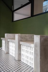 a row of concrete benches in a room with a tile floor at USJ NPW New PinkWay Hotel in Subang Jaya