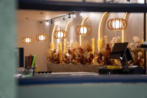 a row of lights on a wall with flowers at USJ NPW New PinkWay Hotel in Subang Jaya