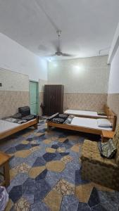a large room with two beds and a couch at Galiyat City hotel in Mingāora +21 photos
