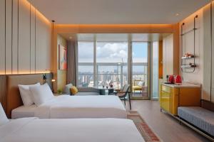 a hotel room with two beds and a view at Hyatt Centric The Ring Chengdu in Chengdu +73 photos