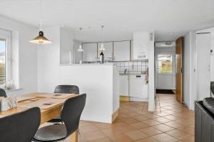 a kitchen and dining room with a table and chairs at G237-Lemvig-Syrenvej-37 in Lemvig