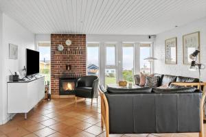 a living room with a couch and a fireplace at G237-Lemvig-Syrenvej-37 in Lemvig