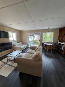 a living room with a couch and a table at Cedar House Ocean View & Access in Roberts Creek