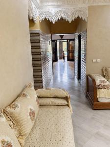 a living room with two beds and a couch at Nzaha house in Douar Ahmed Ben Brahim +52 photos