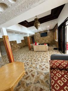 a living room with a couch and a table at Nzaha house in Douar Ahmed Ben Brahim