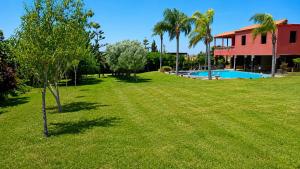 a yard with a house and a swimming pool at Nzaha house in Douar Ahmed Ben Brahim