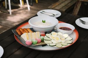a plate of food with sushi and rice on a table at Tingkat Valley in Ipoh