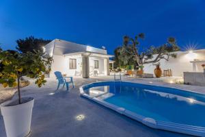 a villa with a swimming pool in front of a house at Villa Narkive in Carovigno