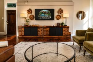 a living room with a couch and a table at The Nama Retreat 201 - Renovated Downtown Loft near Gay St | Walk Everywhere in Knoxville