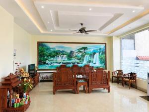 a dining room with a painting on the wall at LiLy Hotel Ninh Bình in Ninh Binh