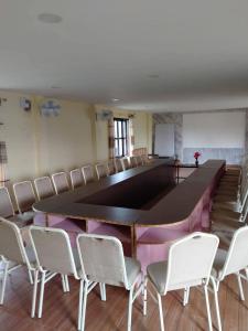 a large conference room with a large table and chairs at silent park sauraha in Sauraha