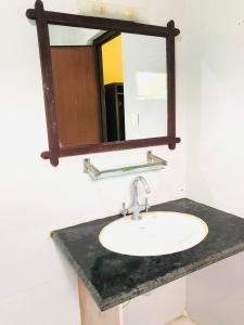a bathroom with a sink and a mirror at silent park sauraha in Sauraha +6 photos