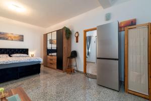 a bedroom with a bed and a refrigerator at Monte Mare in Donji Seget