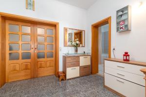 a bathroom with a sink and a wooden door at Monte Mare in Donji Seget +51 photos