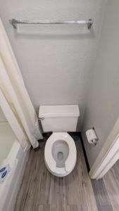 a bathroom with a white toilet and a shower at Queen Bed Hotel Room 225 in Amarillo