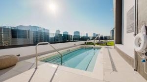 a swimming pool on the roof of a building at District 225 Condo by Ionica in Miami